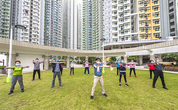 Photo: Deputy Director of Housing (Estate Management), Mr Ricky Yeung (centre front) and Assistant Director (Estate Management) 1, Mr Ian Luk (second row second left) exercise with elderly tenants at Kai Ching Estate, Kowloon City on the day when the 