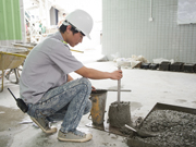 Photo: The Slump Test: first mix the concrete with a shovel and press it into a semi-conical container with an iron rod (left); remove the semi-conical container (middle); and measure the slump (right).