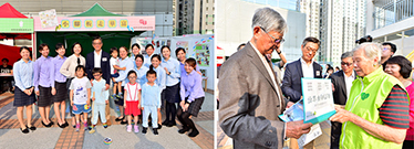 Photo: (Left photo) Director of Housing, Mr Stanley Ying (back row, fifth left) pictured with teachers and students of The Salvation Army Wah Fu Nursery School at the carnival. (Right photo) A community docent introduces features of Wah Fu Estate to Dr Donald Liao (first left) and Mr Stanley Ying (second left).