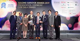 Photo: Deputy Director of Housing (Estate Management), Miss Rosaline Wong (third left), pictured with Assistant Director of Housing (Estate Management), Mr Steve Luk (third right), who receives on behalf of the HD the winner award of Building Surveyor Awards 2019, together with the project team.