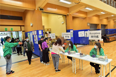 Photo: HD staff (in green jackets) provide administrative support at the community vaccination centre set up at Yau Oi Sports Centre.