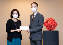 相片：房屋局常任秘书长王天予（左）颁授升职贺函予获擢升为总土木工程师的梁炳文。