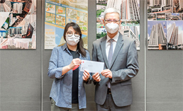 相片：助理署長（工務）林清華（右）頒授升職賀函予獲擢升為一級監工（建築）的黎婉婷。