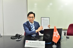 Photo: Mr Daniel Leung signs the Conference Agreement.