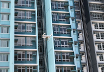 Photo: A drone inspecting external walls of a high-rise building.
