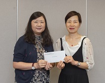 相片：總新聞主任（房屋）／資訊及社區關係總監李月英（左）頒授升職賀函予獲擢升為合約高級宣傳主任的周瑞芳。