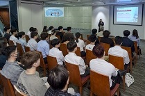 Photo: A colleague from the Training and Development Centre of the Corporate Services Division briefs students on the corporate vision and the scope of HD's work.
