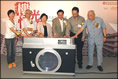 Photo: Chairman of the Housing Authority, Ms Eva Cheng (third from left), together with other guests of honour and representatives of the three old estates, kicks off the "Light and Shade: life passé in old estates" exhibition.