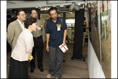 Photo: Photographer Mr John Choy (first from right) introduces to the Guests of Honour his works taken at Lower Ngau Tau Kok Estate.