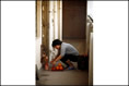 Photo: Kaifong prays in the corridor for God's blessing