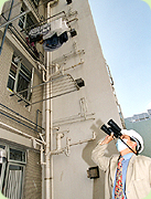 Photo: Exterior pipe inspection performed by Housing Department surveyor.