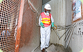 Photo: A Housing Department worker sprays larvicide to prevent mosquito breeding.