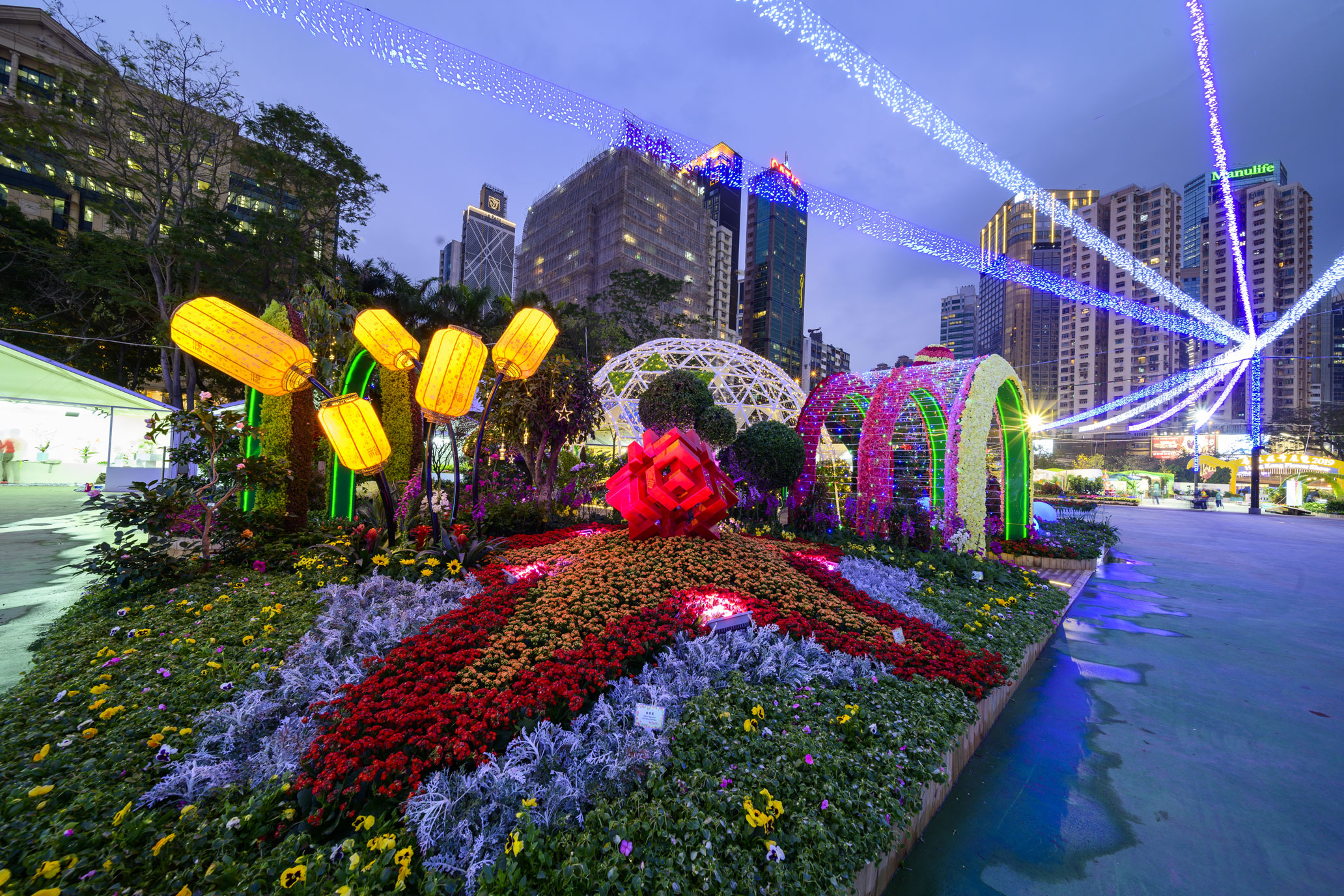 The illuminated 3D HA logo adorned with a sea of dazzling flowers. 1